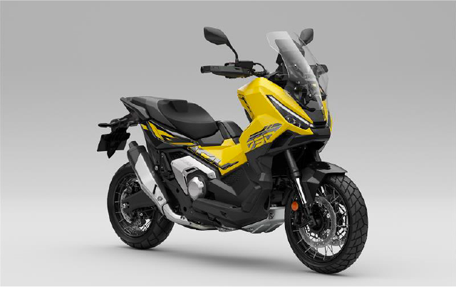 A product photo of a scooter-style motorcycle, characterized by its yellow body, taken from a diagonal front angle
