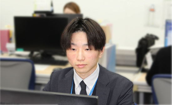 Sさんデスクで仕事をしている様子