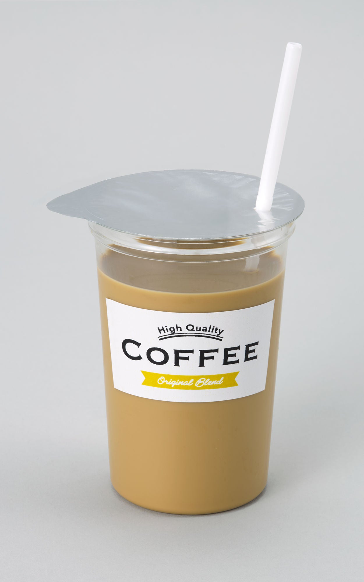 Transparent PET cup filled with coffee, sealed with lidding film and fitted with a drinking straw.